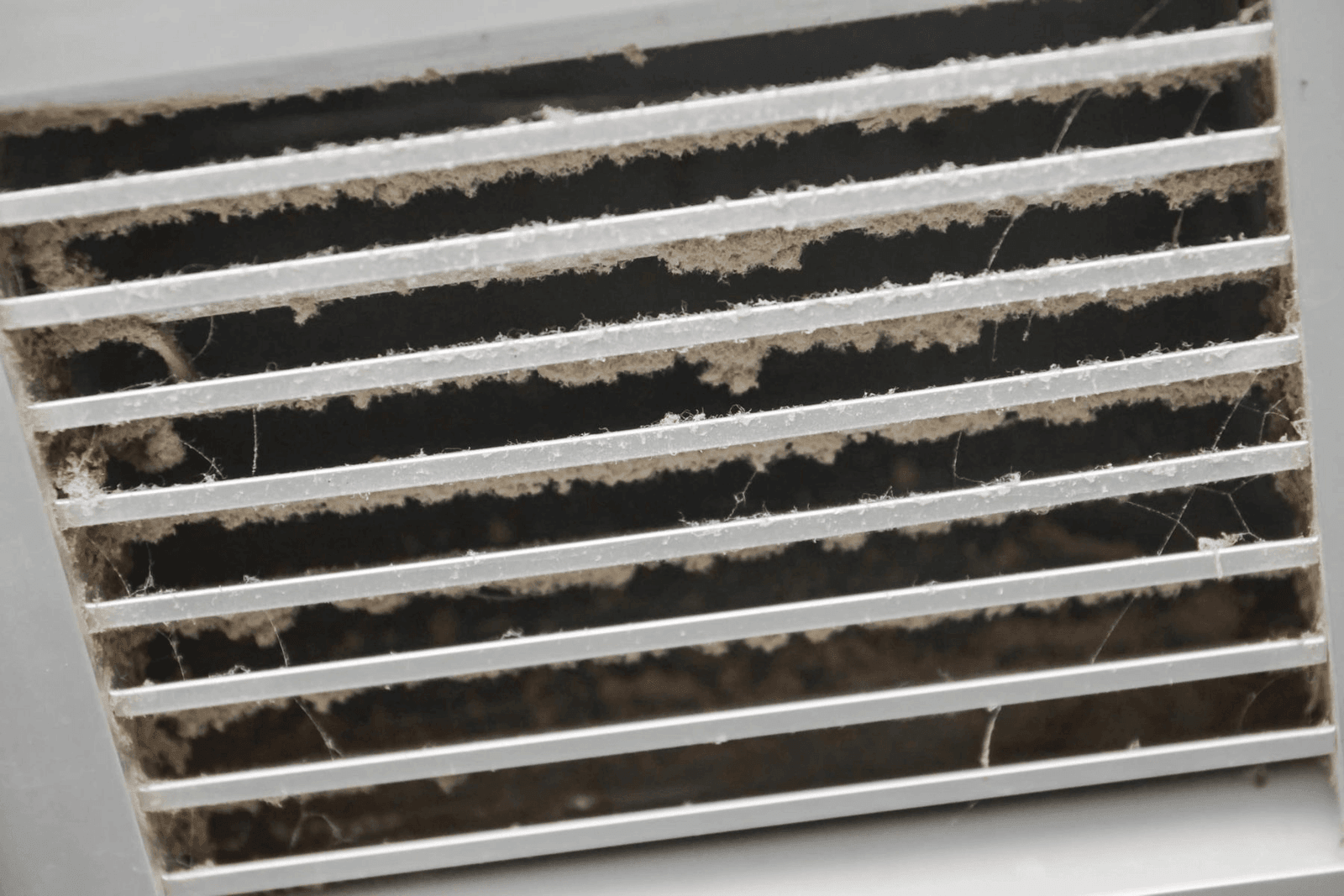 Dusty air vent before professional duct cleaning