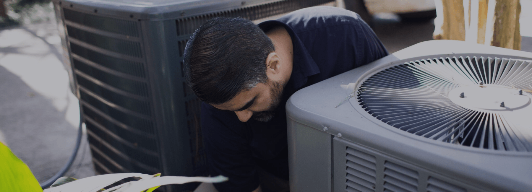 Technician repairing a residential AC system